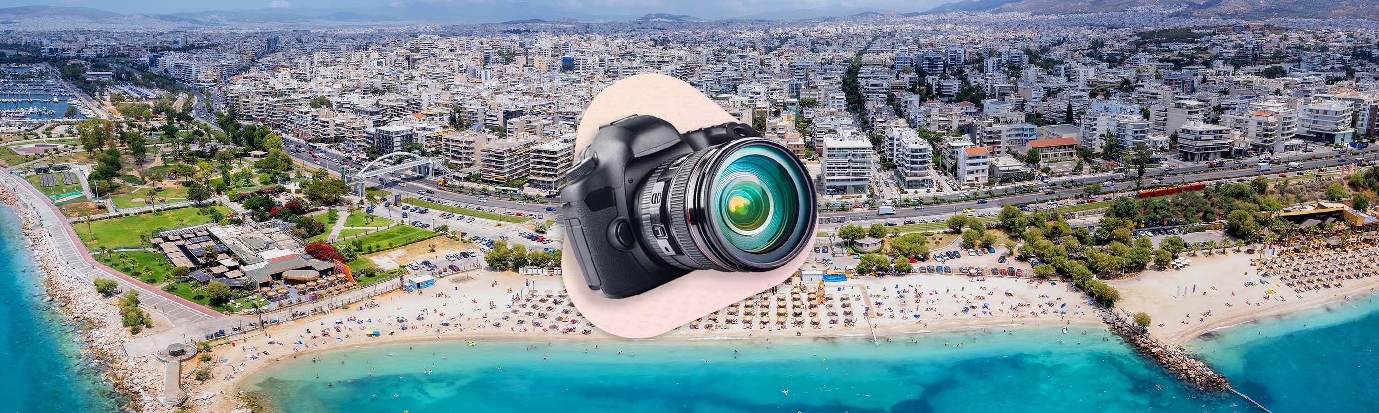 camera in front of the beach and houses with a pink background